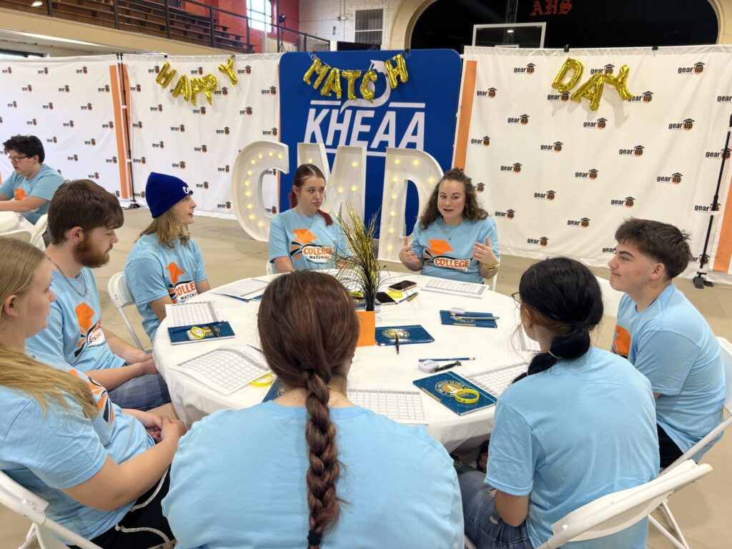 Students sitting around a table at match day